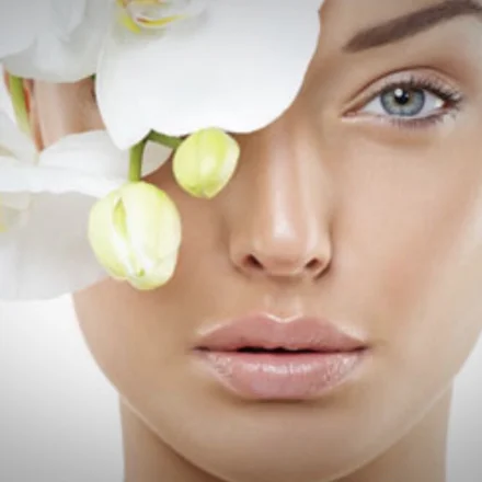 Stock beauty portrait with a white orchid, from Eden’s skin-care page