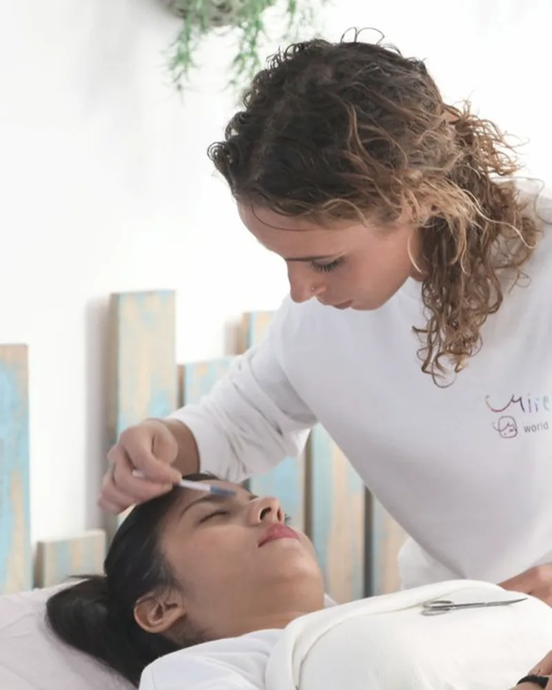 Aesthetician providing a facial treatment in a clinic