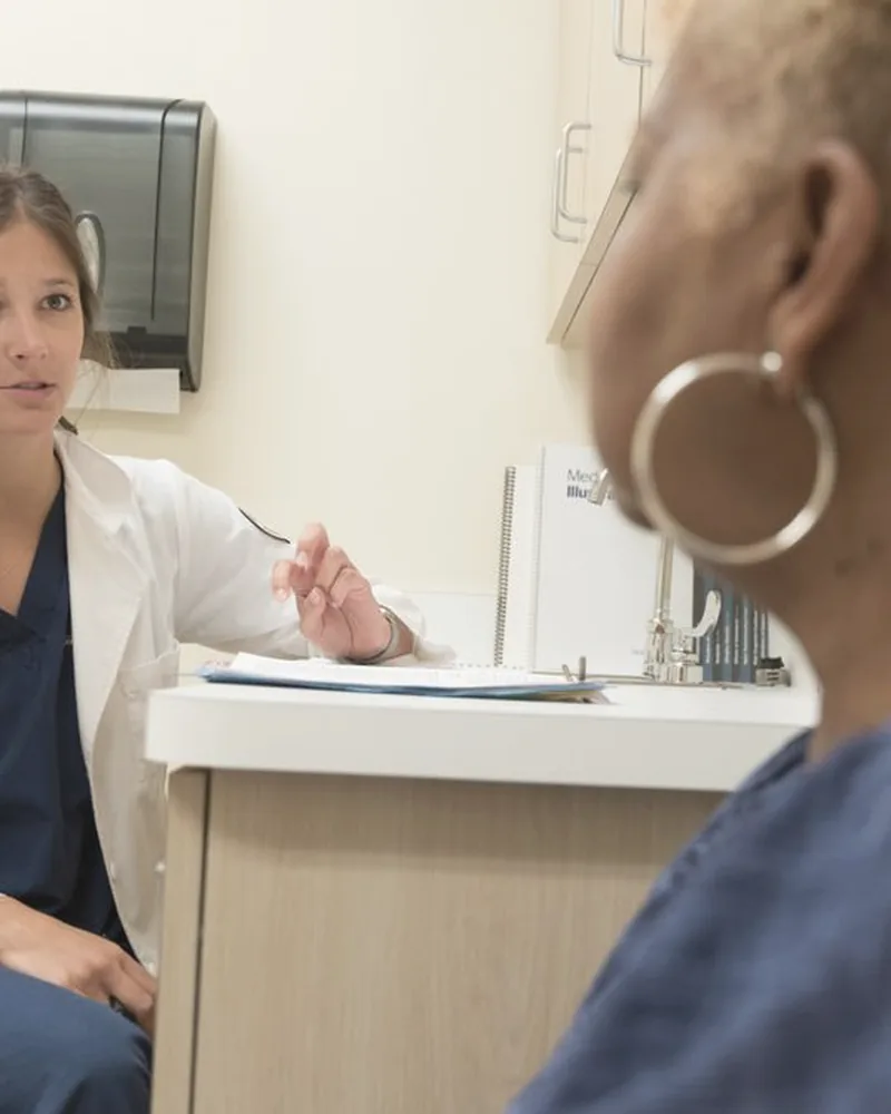 Patient speaking with a clinician in a medical office